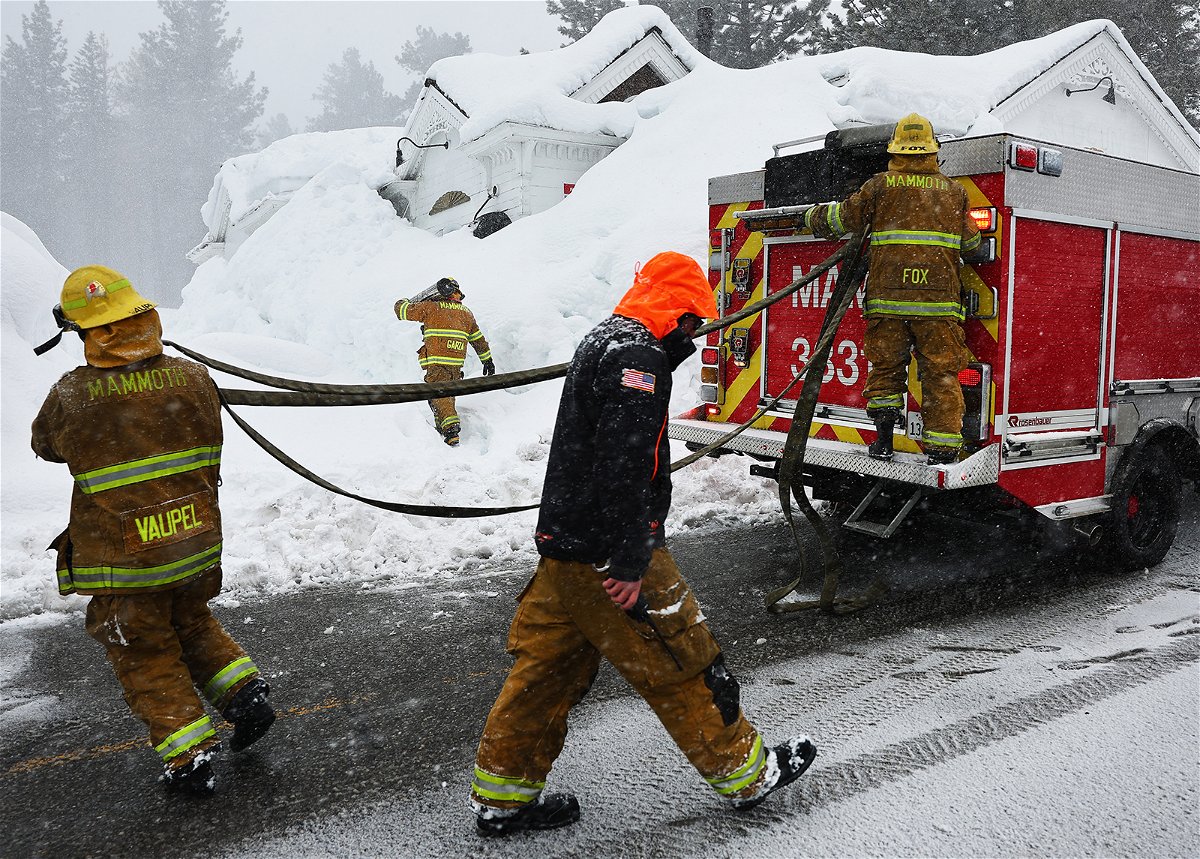 <i>Mario Tama/Getty Images</i><br/>Mammoth Lakes Fire Department firefighters respond to a propane heater leak and small fire at a shuttered restaurant surrounded by snowbanks Sunday in Mammoth Lakes