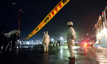 Police officers restrict entry into Saikazaki port in Wakayama