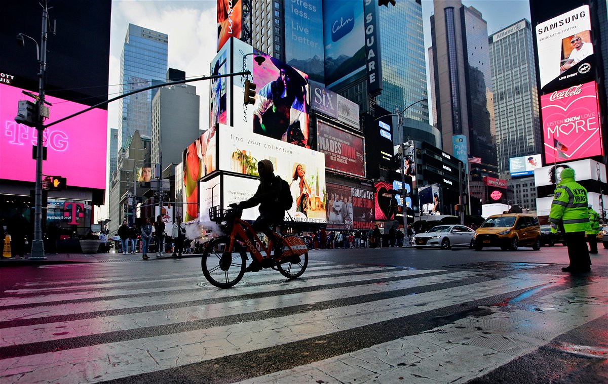 <i>Leonardo Munoz/VIEWpress/Getty Images</i><br/>A man rides an e-bike through Times Square on February 21