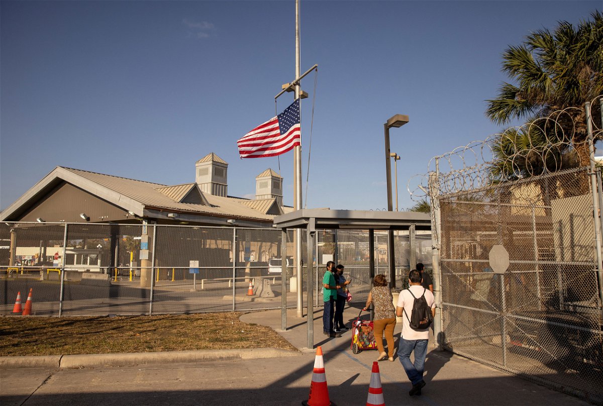 <i>John Moore/Getty Images</i><br/>The U.S. flag flies at half-staff at a port of entry at the U.S.-Mexico border in February 2021 in Brownsville