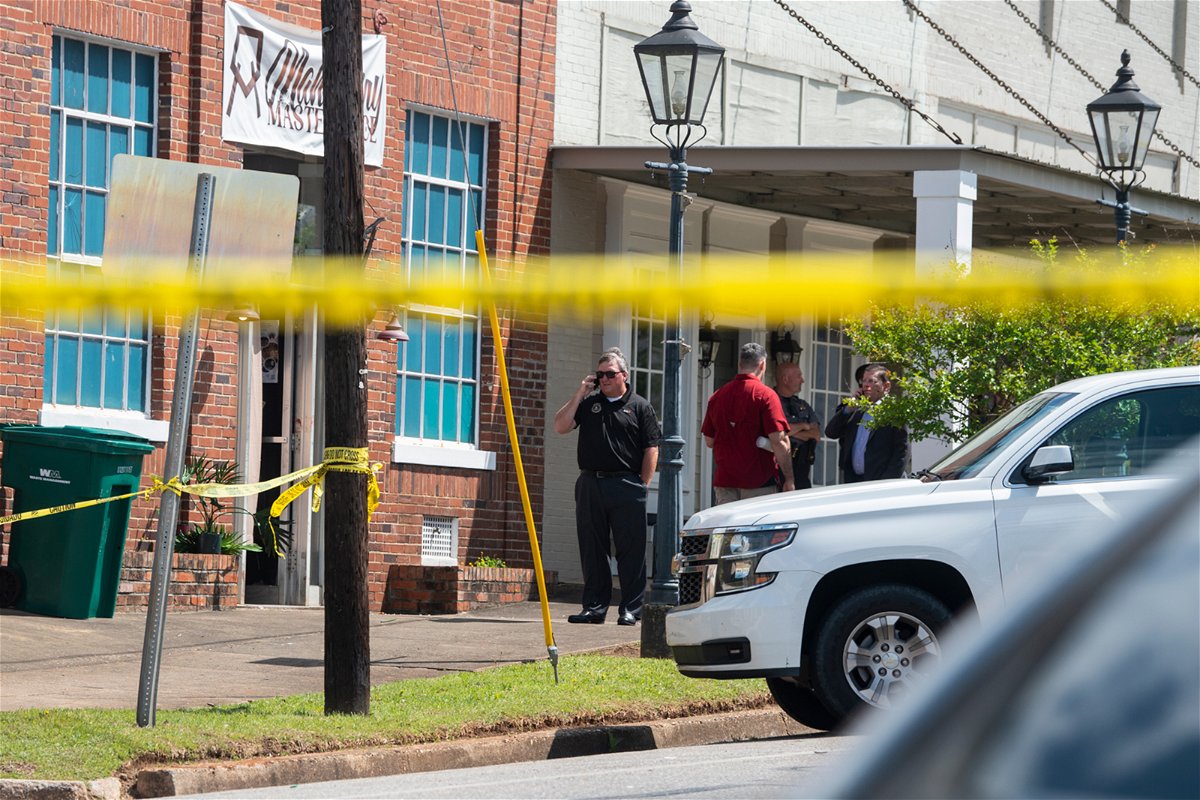 <i>Jake Crandall/AP</i><br/>Law enforcement officers investigate the day after the shooting at a venue in downtown Dadeville