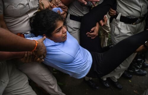 Indian wrestler Sakshi Malik is detained by the police while attempting to march to India's new parliament in New Delhi on May 28