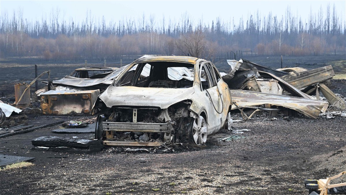 <i>Walter Tychnowicz/AFP via Getty Images</i><br/>Damaged vehicles sit near the property of Adam Norris