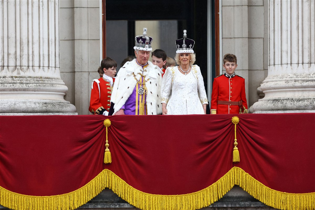 <i>Hannah McKay/Reuters</i><br/>Britain's King Charles and Queen Camilla stand on the Buckingham Palace balcony following their coronation ceremony in London on Saturday.
