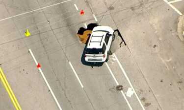 A white SUV appears to have fallen into a large sinkhole along Ponce De Leon and Penn Avenue in Atlanta