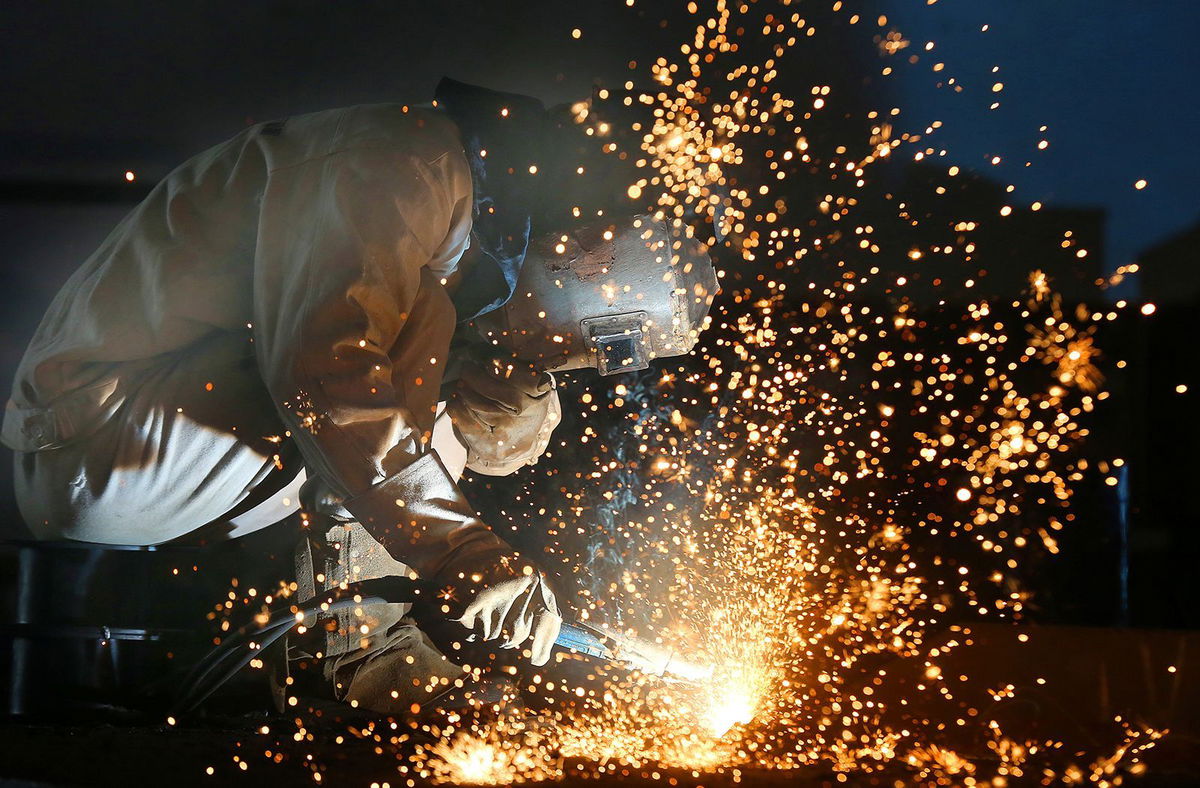 <i>China Daily CDIC/Reuters/File</i><br/>A worker works on a production line at a factory of a ship equipments manufacturer