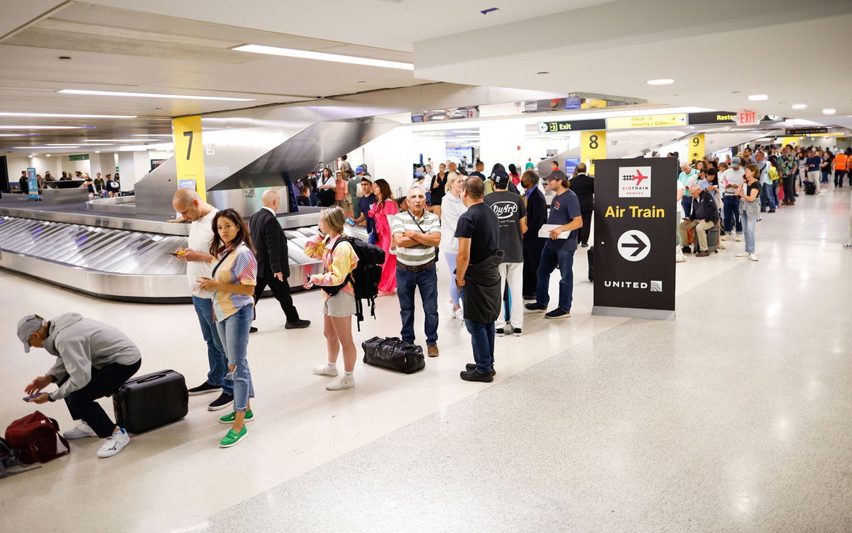 Individuals assemble and await the rescheduling of their flights at Newark International Airport on June 27 in Newark