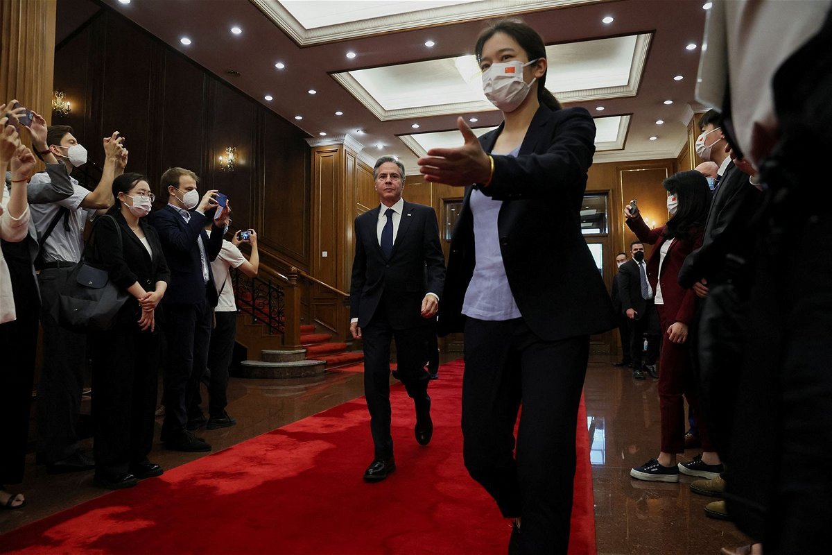 <i>Leah Millis/Reuters</i><br/>U.S. Secretary of State Antony Blinken walks as he arrives to meet with China's Director of the Office of the Central Foreign Affairs Commission Wang Yi (not pictured) at the Diaoyutai State Guesthouse in Beijing