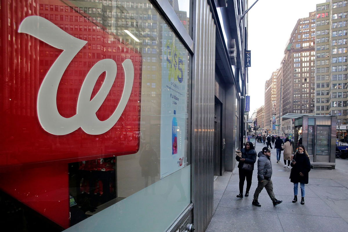 <i>Leonardo Munoz/VIEWpress/Corbis/Getty Images</i><br/>People make their way near a Walgreens pharmacy on March 09