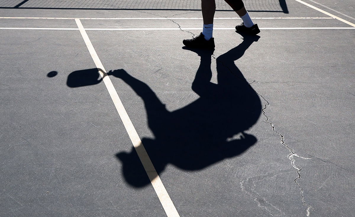 A player's shadow is seen during a game of pickleball on April 12