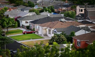 Mortgage rates reportedly ticked lower for the third week in a row. Pictured here are homes in a Los Angeles