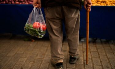 A man buys food in a weekly street market in Istanbul