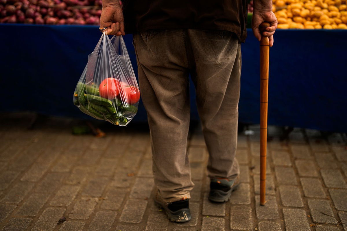 <i>Francisco Seco/AP</i><br/>A man buys food in a weekly street market in Istanbul