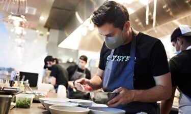 Chef Rob Rubba prepares a tomato dish at his restaurant Oyster Oyster in Washington