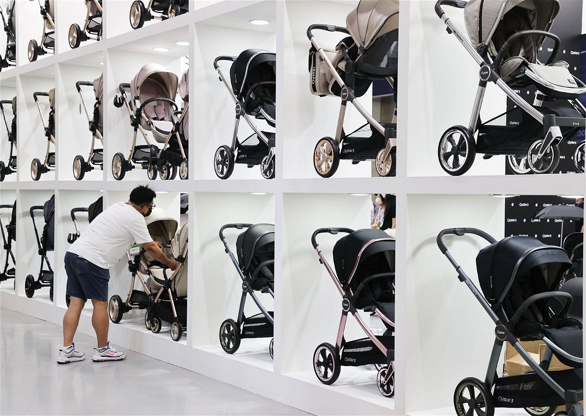 A man looks at strollers at a baby fair in Seoul