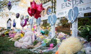 Flowers and stuffed animals are left beside crosses at a memorial outside The Covenant School in Nashville