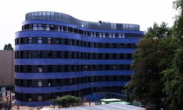 Blue tiles clad the curved building.