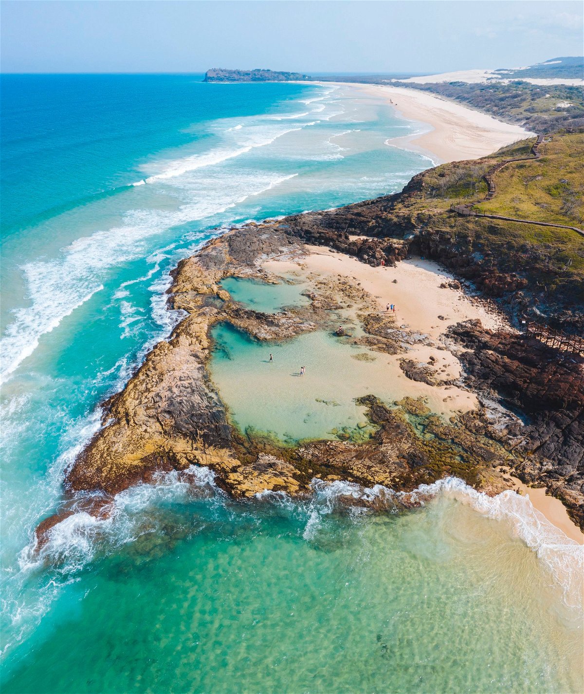 <i>Reuben Nutt/Tourism and Events Queensland</i><br/>The island's famous Champagne Pools decorate its 75-mile beach.