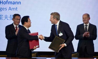 China's Premier Li Qiang (L) and German Chancellor Olaf Scholz (R) look on as the Chairman of China's National Development and Reform Commission (NDRC) Zheng Shanjie (2nd L) and Oliver Zipse (2nd R)