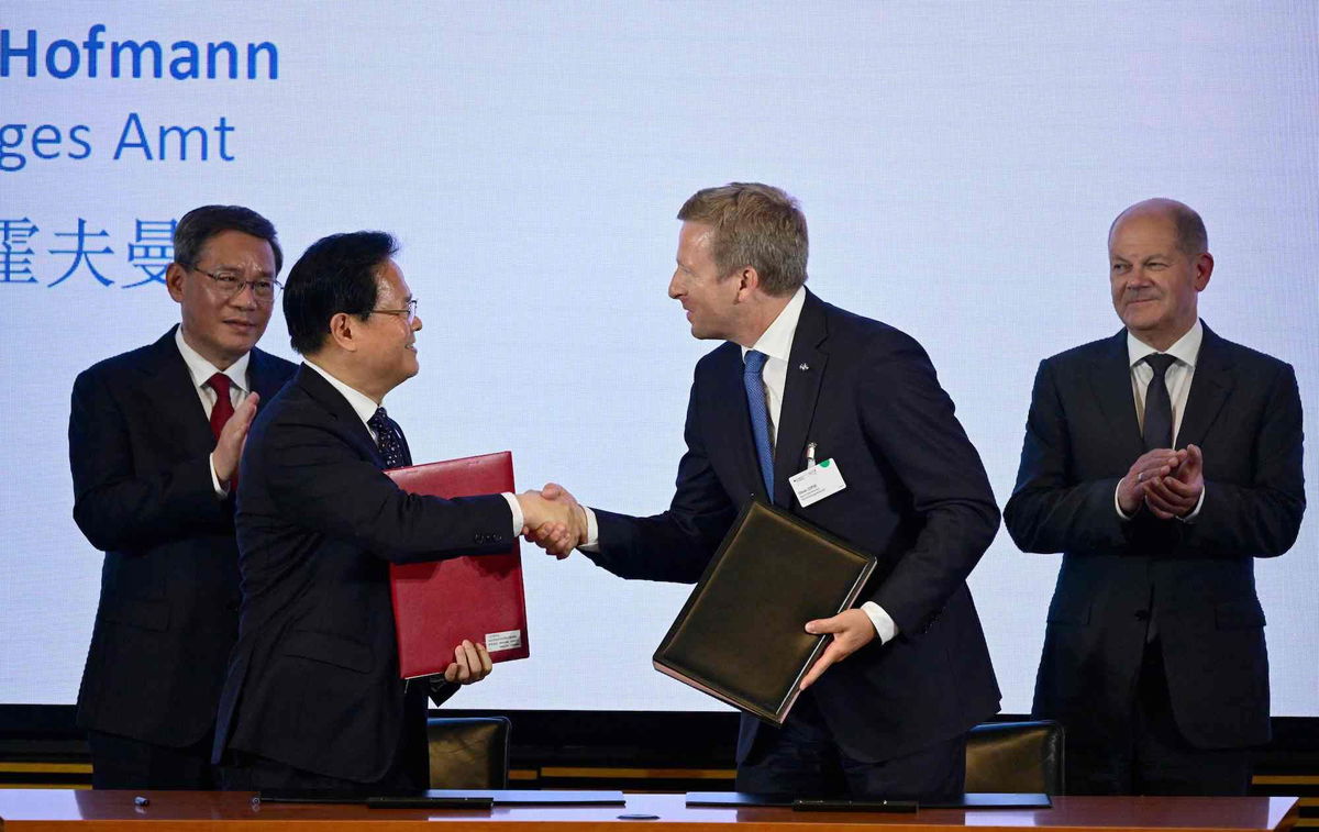 <i>John MacDougall/AFP/Getty Images</i><br/>China's Premier Li Qiang (L) and German Chancellor Olaf Scholz (R) look on as the Chairman of China's National Development and Reform Commission (NDRC) Zheng Shanjie (2nd L) and Oliver Zipse (2nd R)