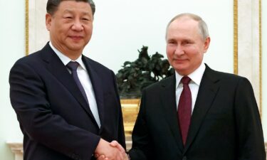 Chinese President Xi Jinping and Russian President Vladimir Putin pose for a photo during their meeting at the Kremlin in Moscow