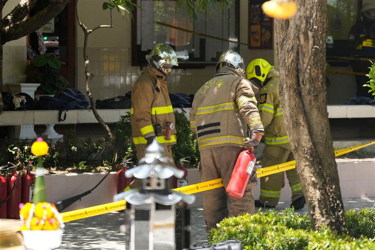 <i>Sakchai Lalit/AP</i><br/>Firefighters investigate an explosion site at a school in Bangkok