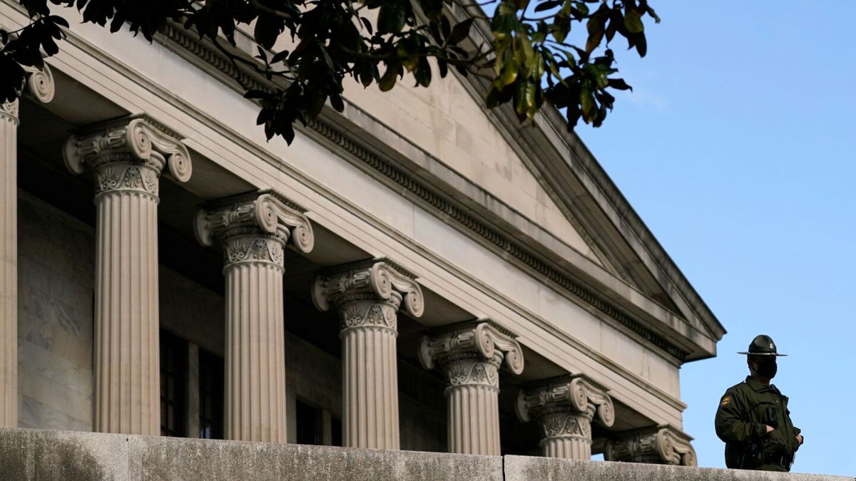 <i>Mark Humphrey/AP</i><br/>A Tennessee State Trooper stands guard on the grounds of the State Capitol in January 2021 in Nashville