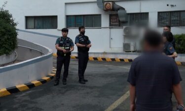 Police officers outside a woman's residence in Suwon