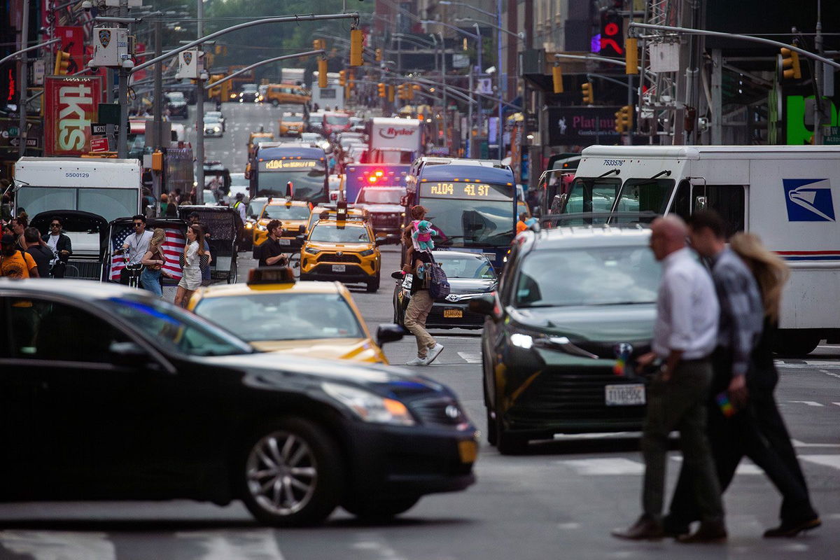 <i>Michael Nagle/Bloomberg/Getty Images/FILE</i><br/>Pedestrians cross a street past traffic in the Midtown neighborhood of New York on June 17.