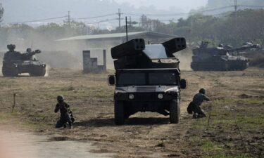 Soldiers hold positions next to a US-made Avenger air defense missile system launcher during an annual military drill in Taichung