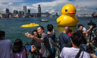 People visit the installation "Double Ducks" by Dutch artist Florentijn Hofman after one of the ducks was deflated at Victoria Harbour in Hong Kong on June 10.