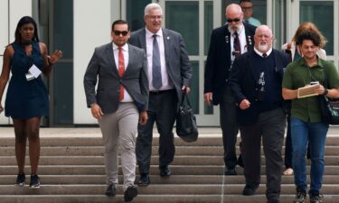 Rep. George Santos walks with his lawyer Joseph Murray outside the Central Islip Federal Courthouse on the day of his hearing