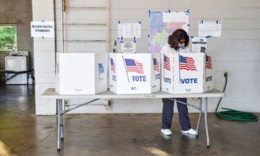 A Jackson resident stops to vote before work in the Mississippi Congressional primary at Fire Station 26 in Jackson