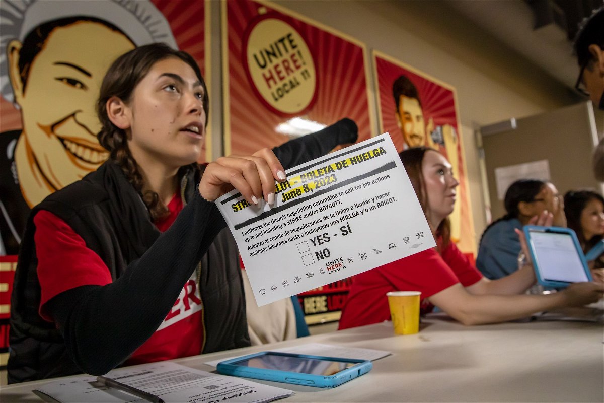 <i>Irfan Khan/Los Angeles Times/Getty Images</i><br/>Marissa Langley attends to hotel workers coming for a strike authorization vote at the Unite Here 11 office in Los Angeles on June 8.
