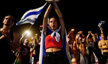 A person gestures as protesters block Ayalon Highway during a demonstration following a parliament vote on a contested bill that limits Supreme Court powers to void some government decisions