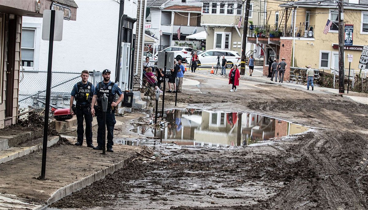 <i>Brian Snyder/Reuters</i><br/>Residents look over the damage after flooding in Montpelier