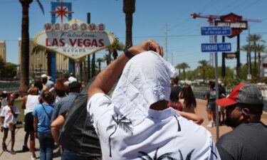 A man cools off under misters in Phoenix on July 14