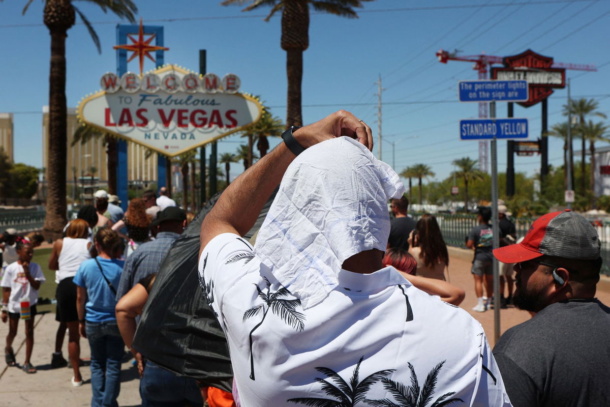 <i>Matt York/AP</i><br/>A man cools off under misters in Phoenix on July 14