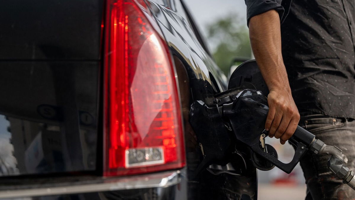 <i>Brandon Bell/Getty Images</i><br/>A person pumps gas at a Chevron gas station on May 26