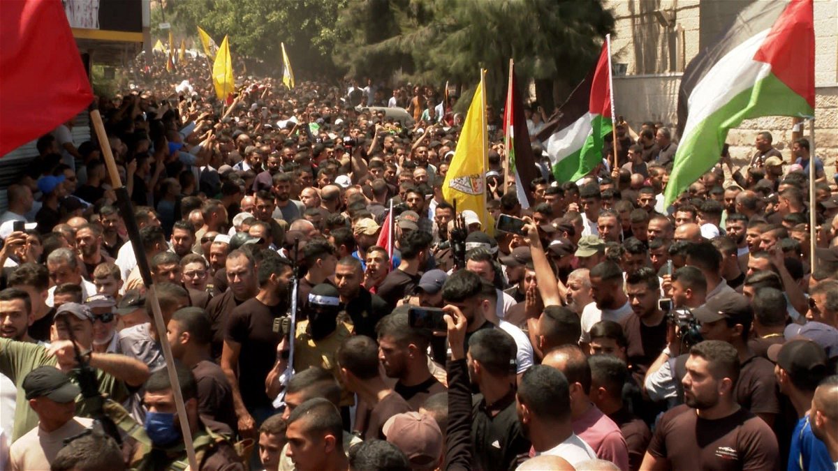 Celebratory gunfire rang out as thousands marched through the streets of Jenin and its camp to join the funeral procession that quickly turned into a demonstration of resistance.