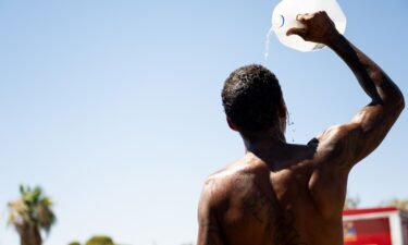 A person cools off amid searing heat on July 16 in Phoenix