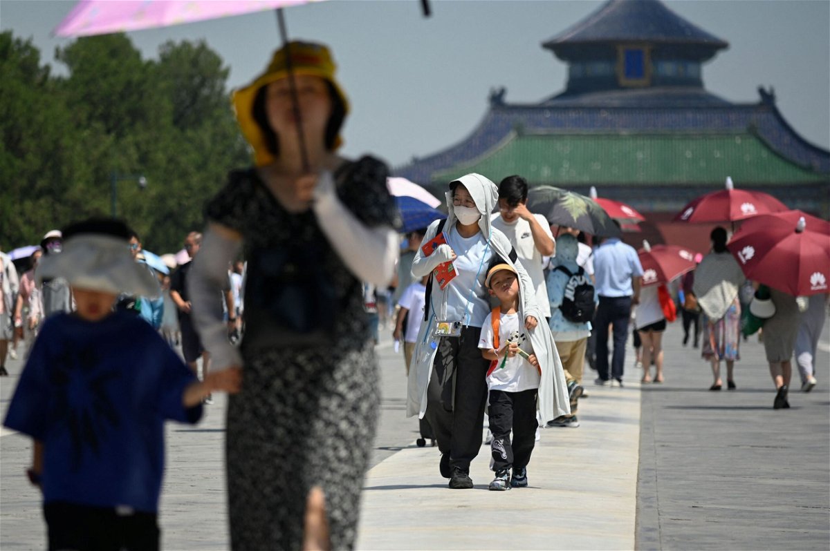 Tourists visit the Temple of Heaven on a hot day in Beijing on June 30.