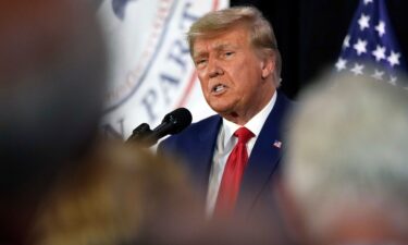 Former President Donald Trump visits with campaign volunteers at the Elks Lodge in Cedar Rapids