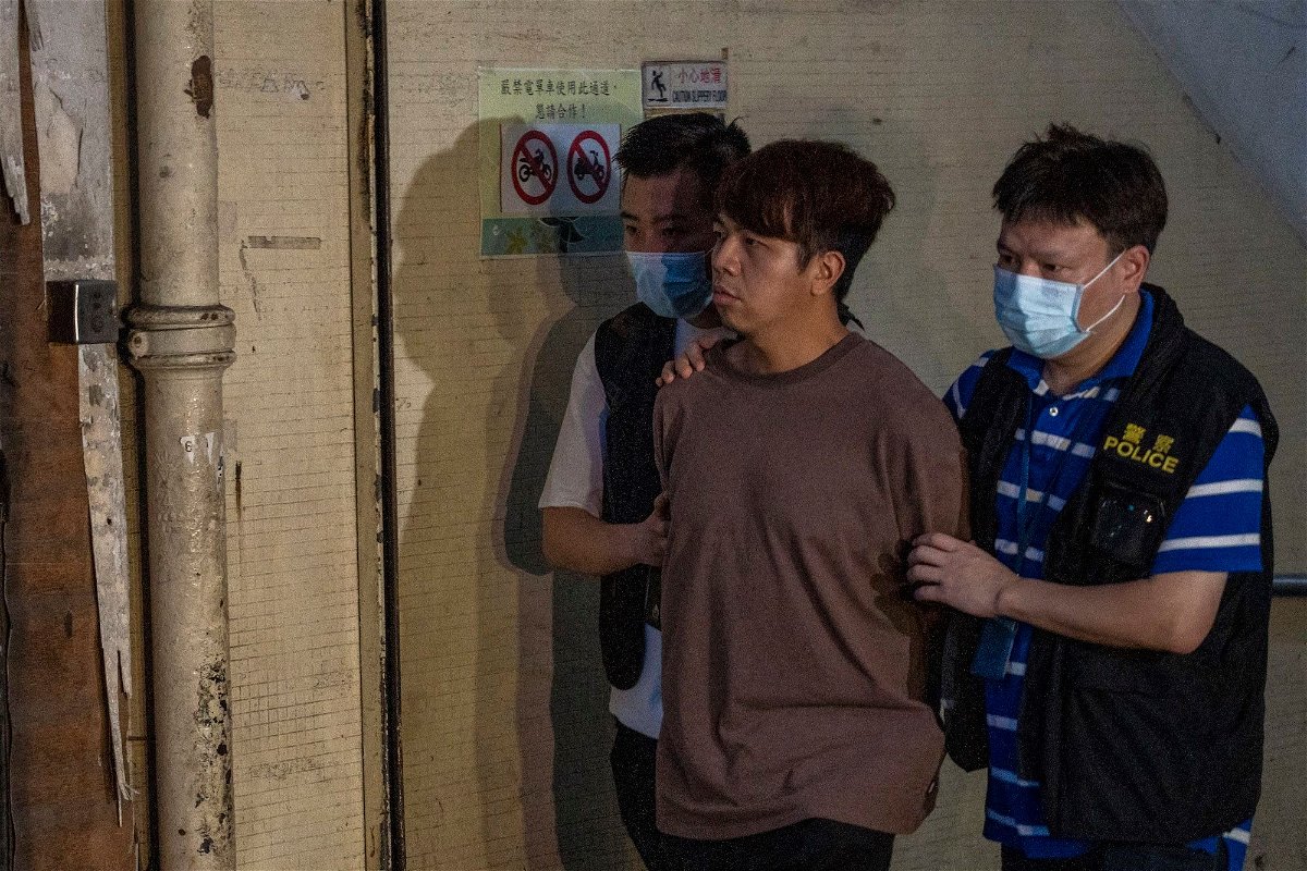 <i>Vernon Yuen/NurPhoto/Getty Images</i><br/>Police officers escort Ivan Lam on July 5
