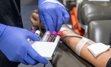 A nurse fills test tubes with blood to be tested during an American Red Cross bloodmobile in Fullerton