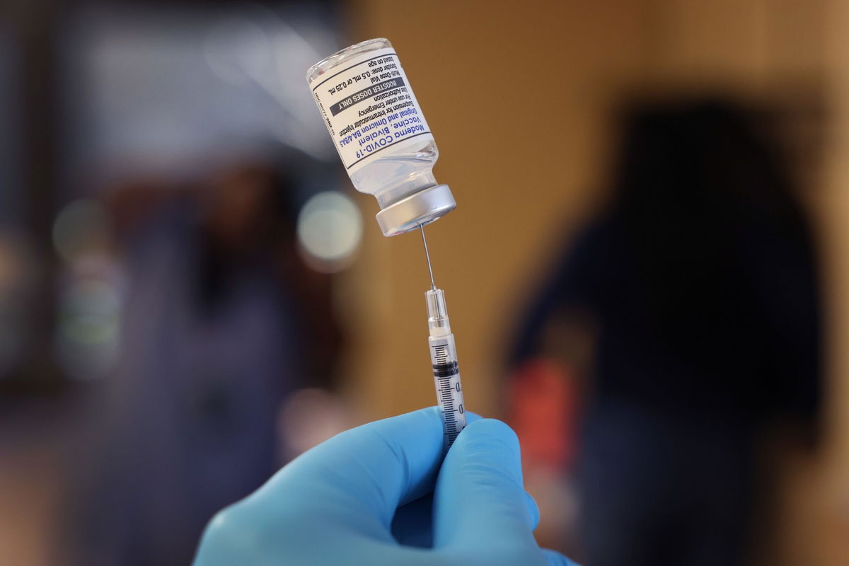 <i>Scott Olson/Getty Images</i><br/>A pharmacist prepares to administer a bivalent COVID-19 vaccine booster shots during an event hosted by the Chicago Department of Public Health at the Southwest Senior Center on September 9