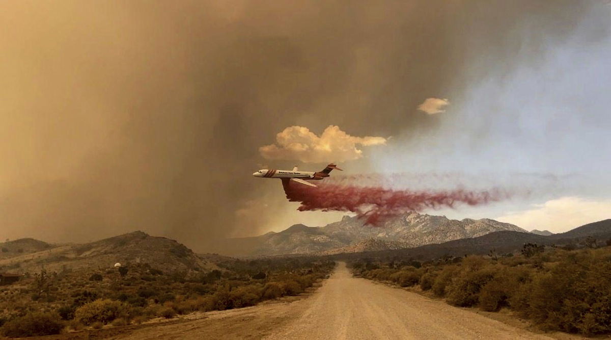 <i>R. Almendinger/InciWeb/National Park Service Mojave National Preserve/AP</i><br/>A tanker makes a fire retardant drop over the York Fire in Mojave National Preserve on Saturday.