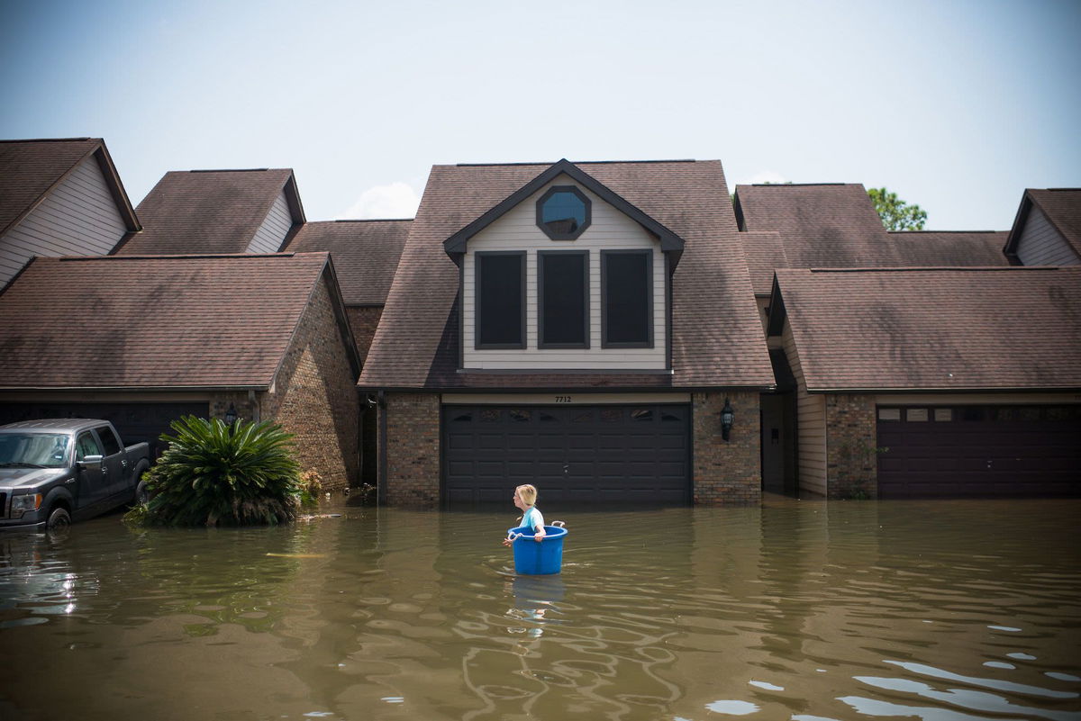 <i>Emily Kask/AFP/Getty Images</i><br/>Jenna Fountain carries a bucket to recover items in Port Arthur