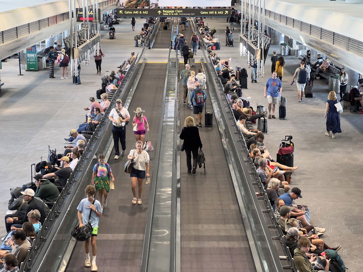 <i>Daniel Slim/AFP/Getty Images</i><br/>Travelers walk through Denver International Airport in Colorado