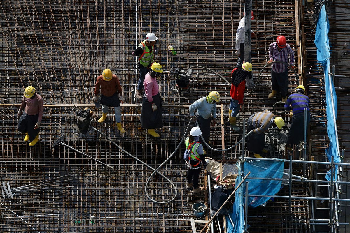 <i>Edgar Su/Reuters/File</i><br/>Migrant workers sit in the back of a lorry in Singapore on May 15